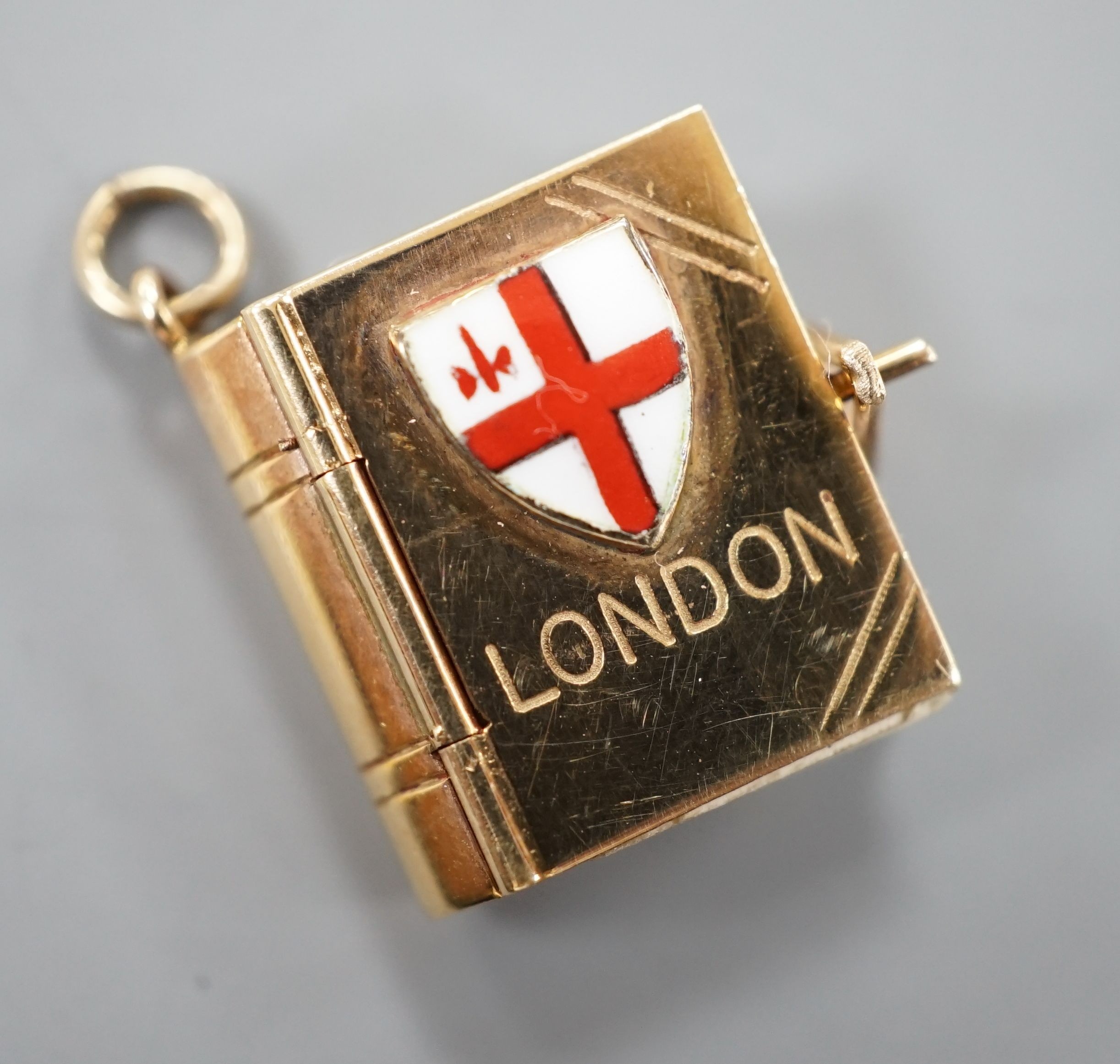 An enamelled 9ct gold photograph album charms with views and crest of London, 1.5cm gross 3.1 grams